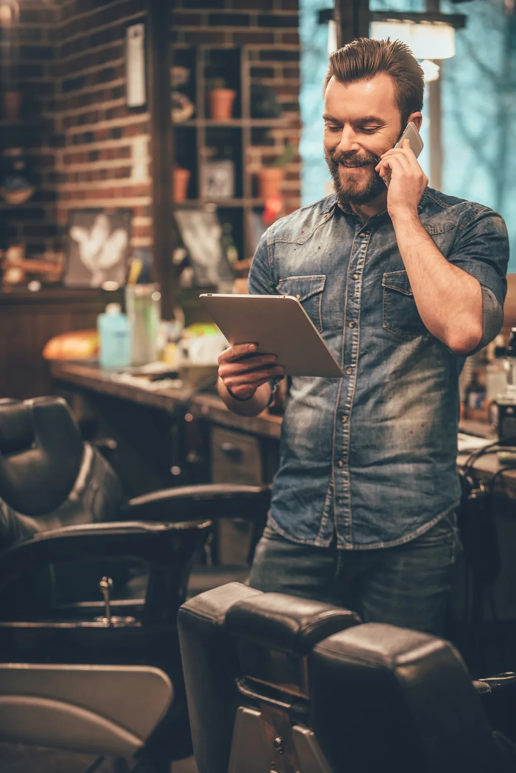 Small business owner reviewing SEO results on tablet — SEO services for small businesses by BDX Omaha