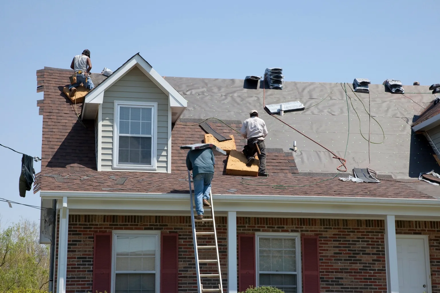 Roofing contractor completing a full roof replacement on a residential home